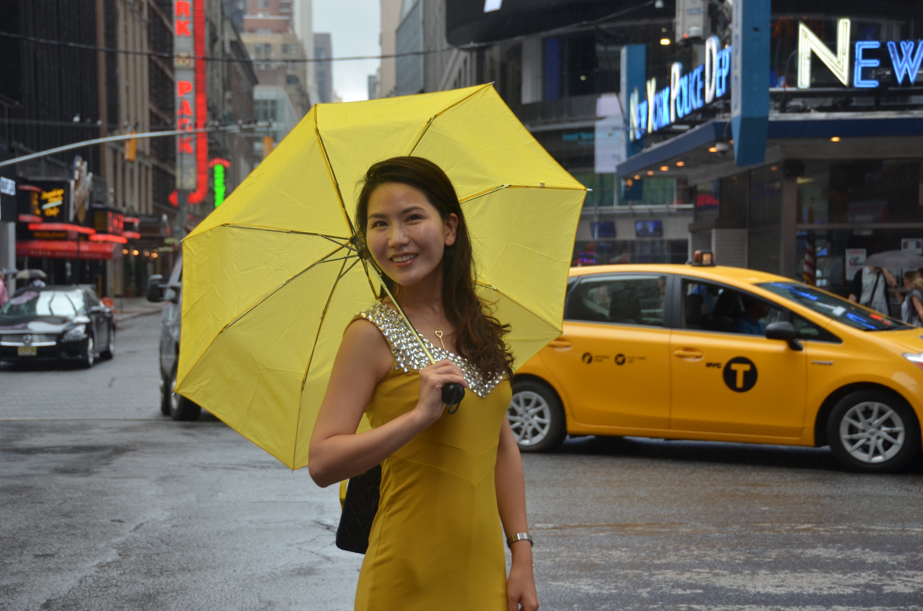 Jinny Son with yellow umbrella in Times Square