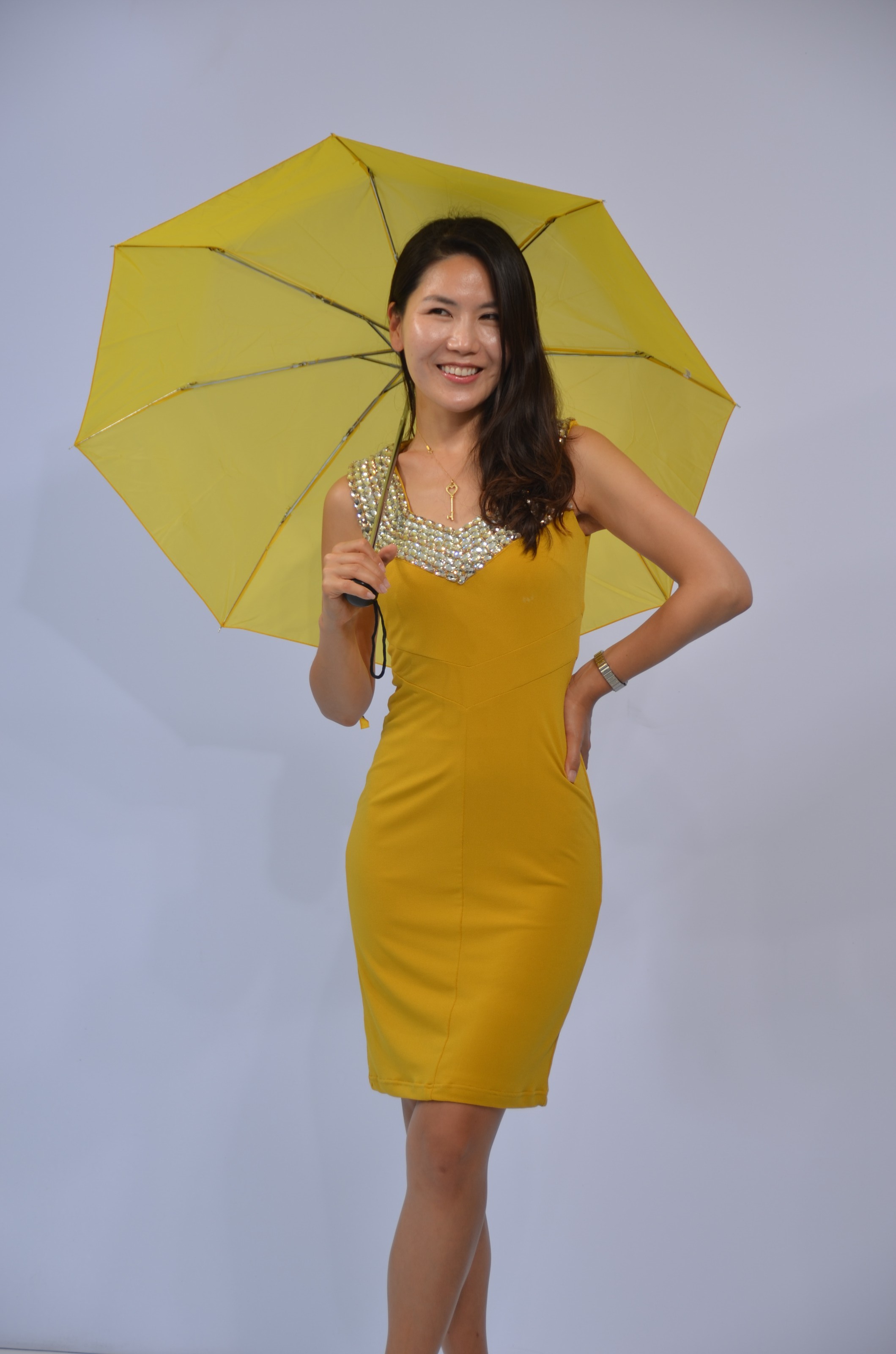 pretty girl in yellow dress and umbrella