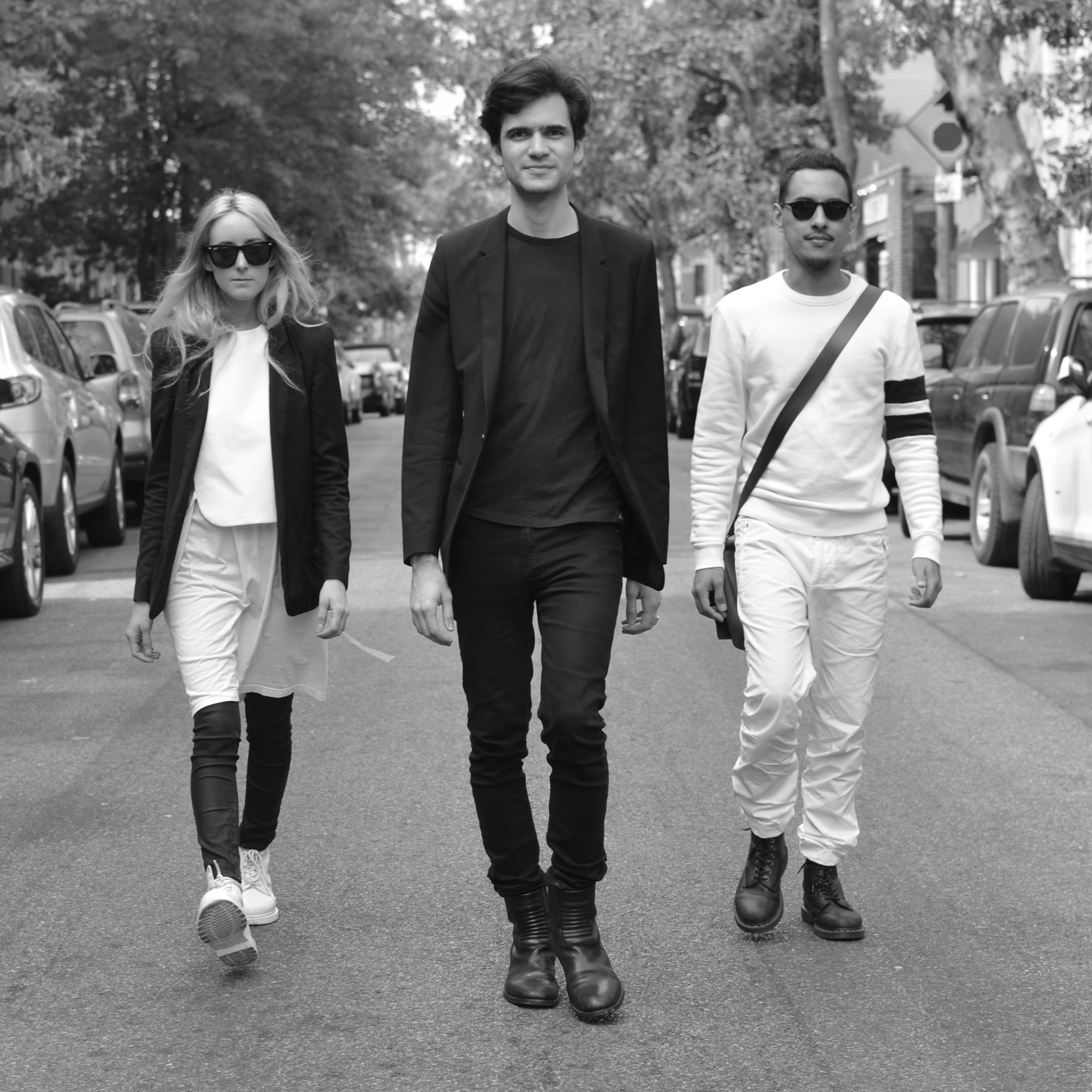three people walking on NYC street