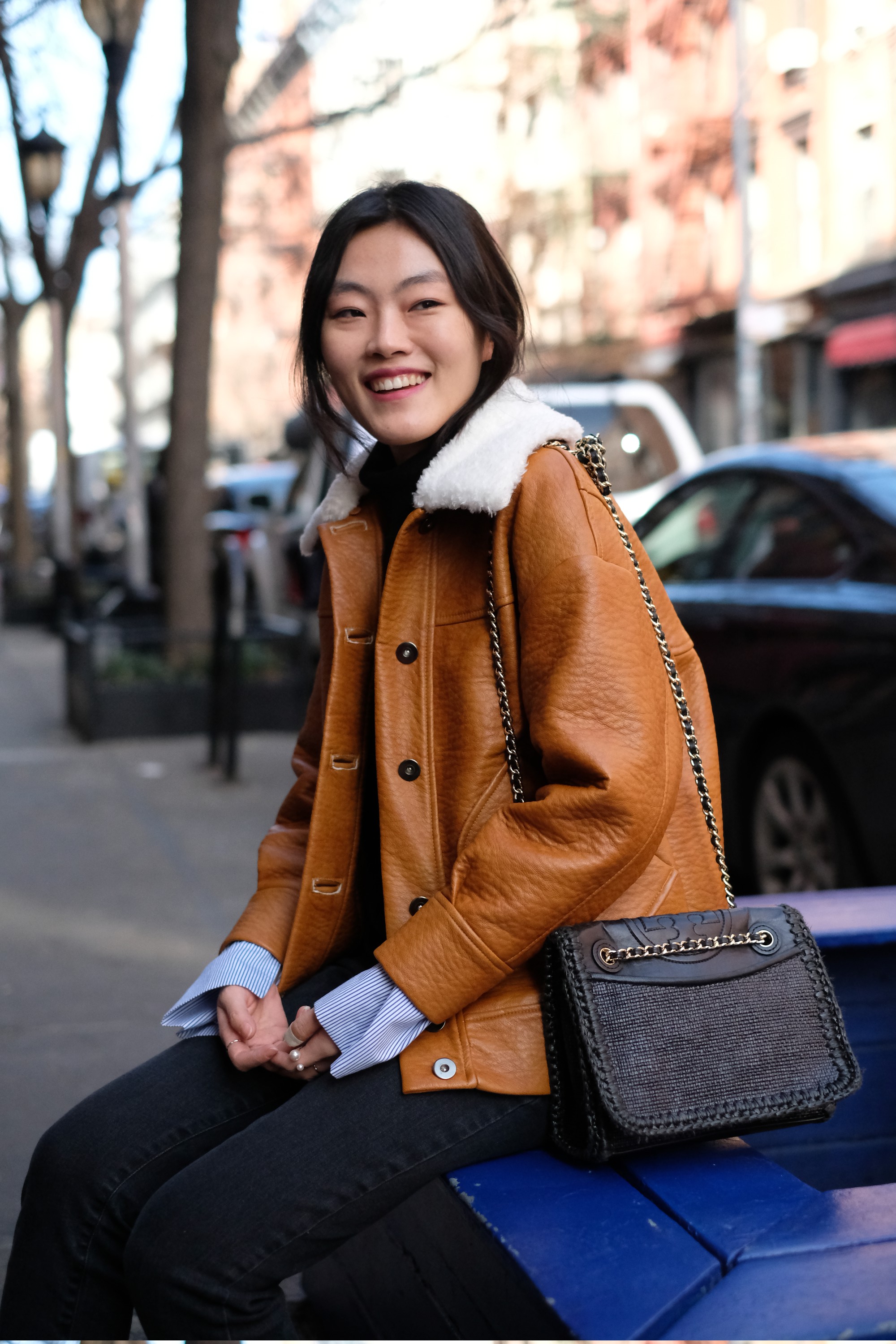 Asian girl in textured brown leather jacet