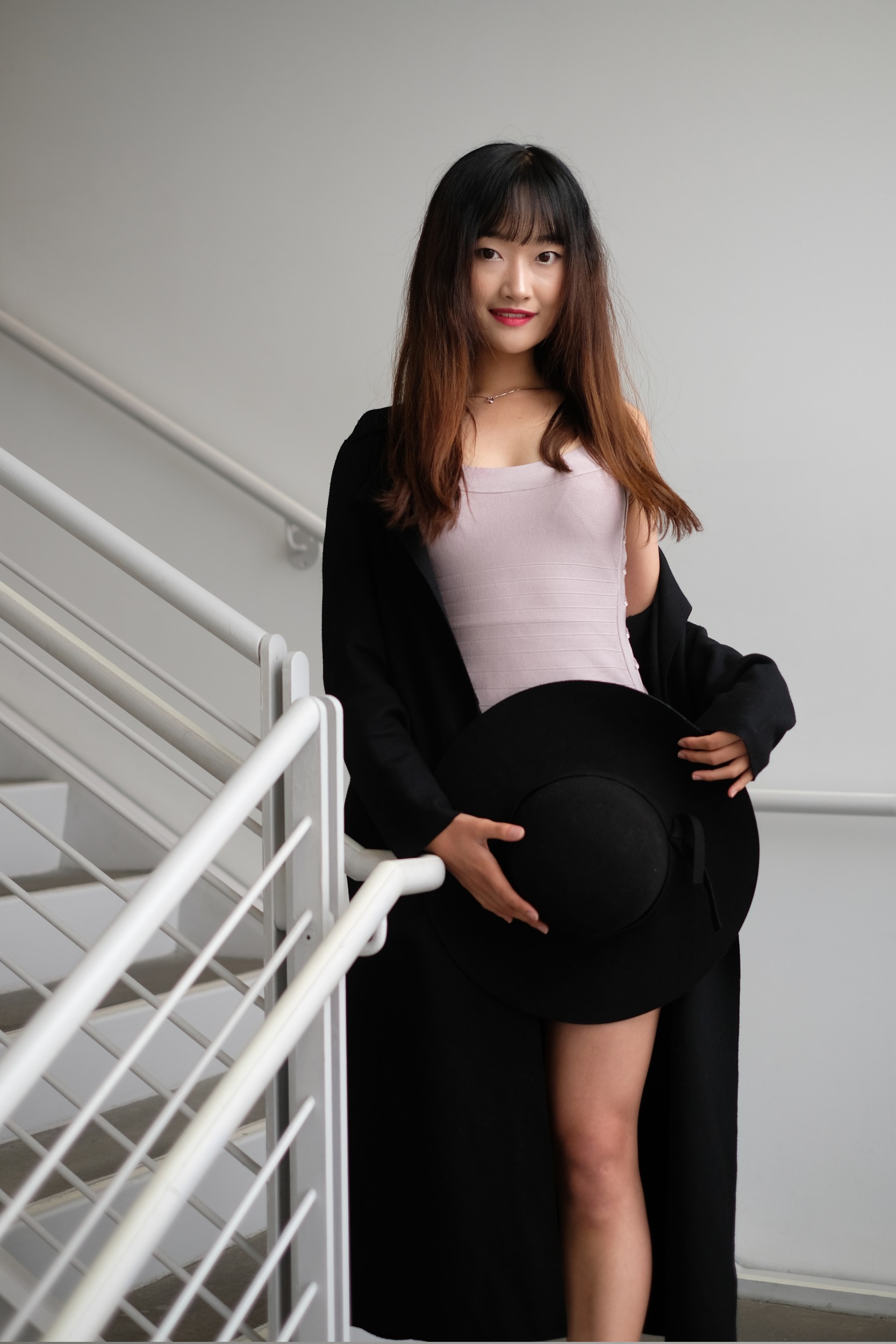 Chinese girl in black coat in stairwell