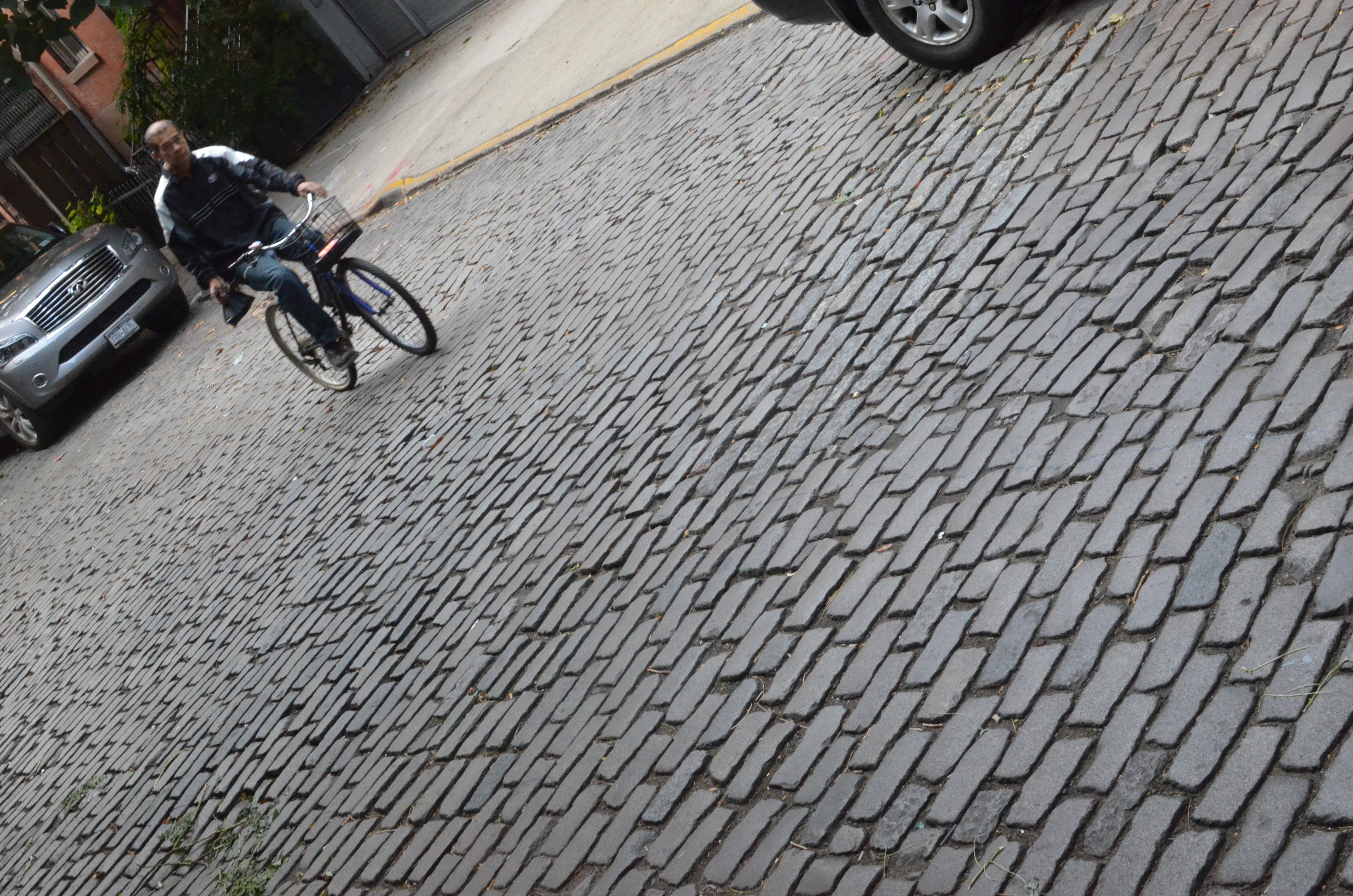 bicyclist on a cobblestone street