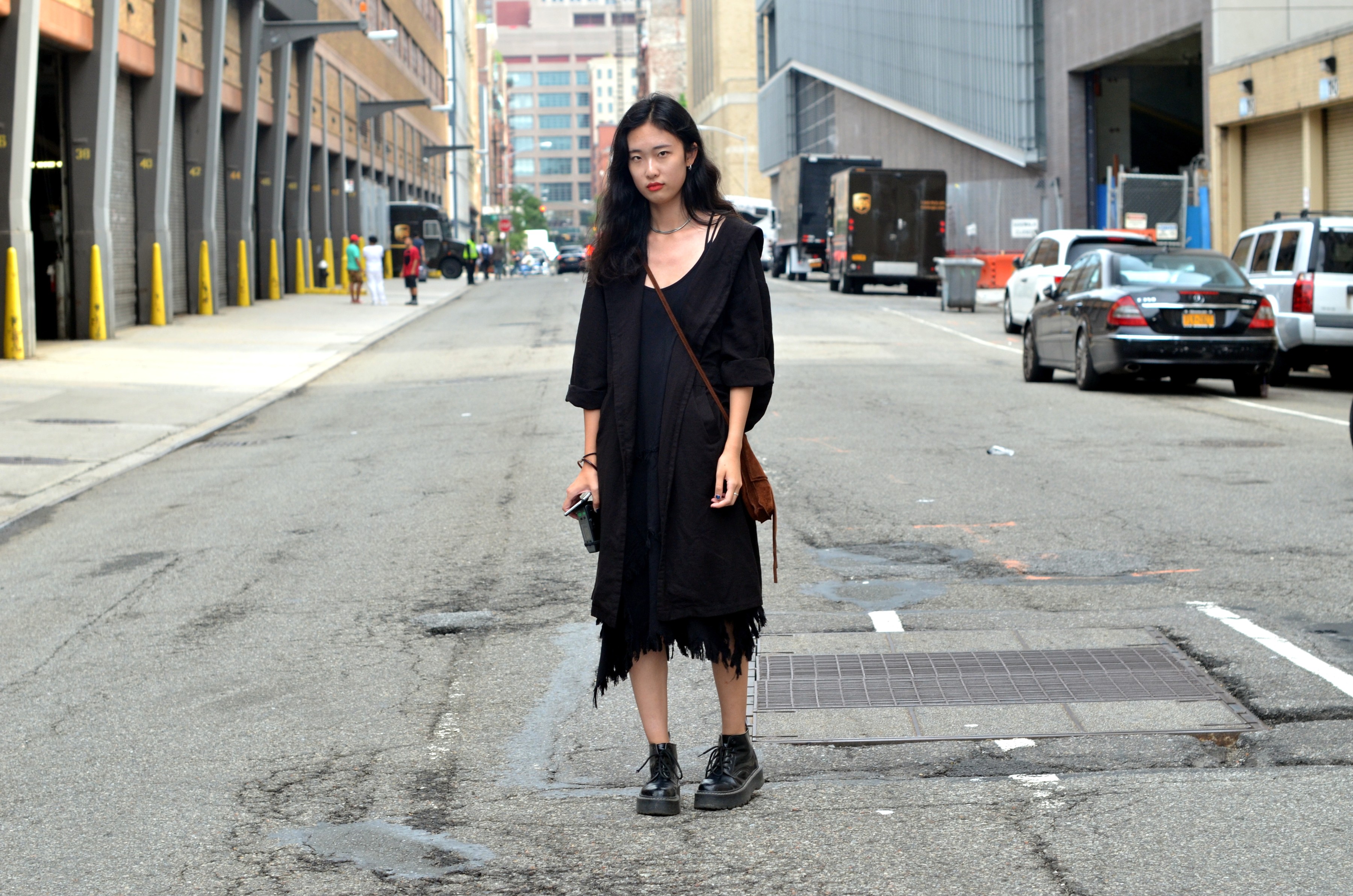 asian girl in black dress in street