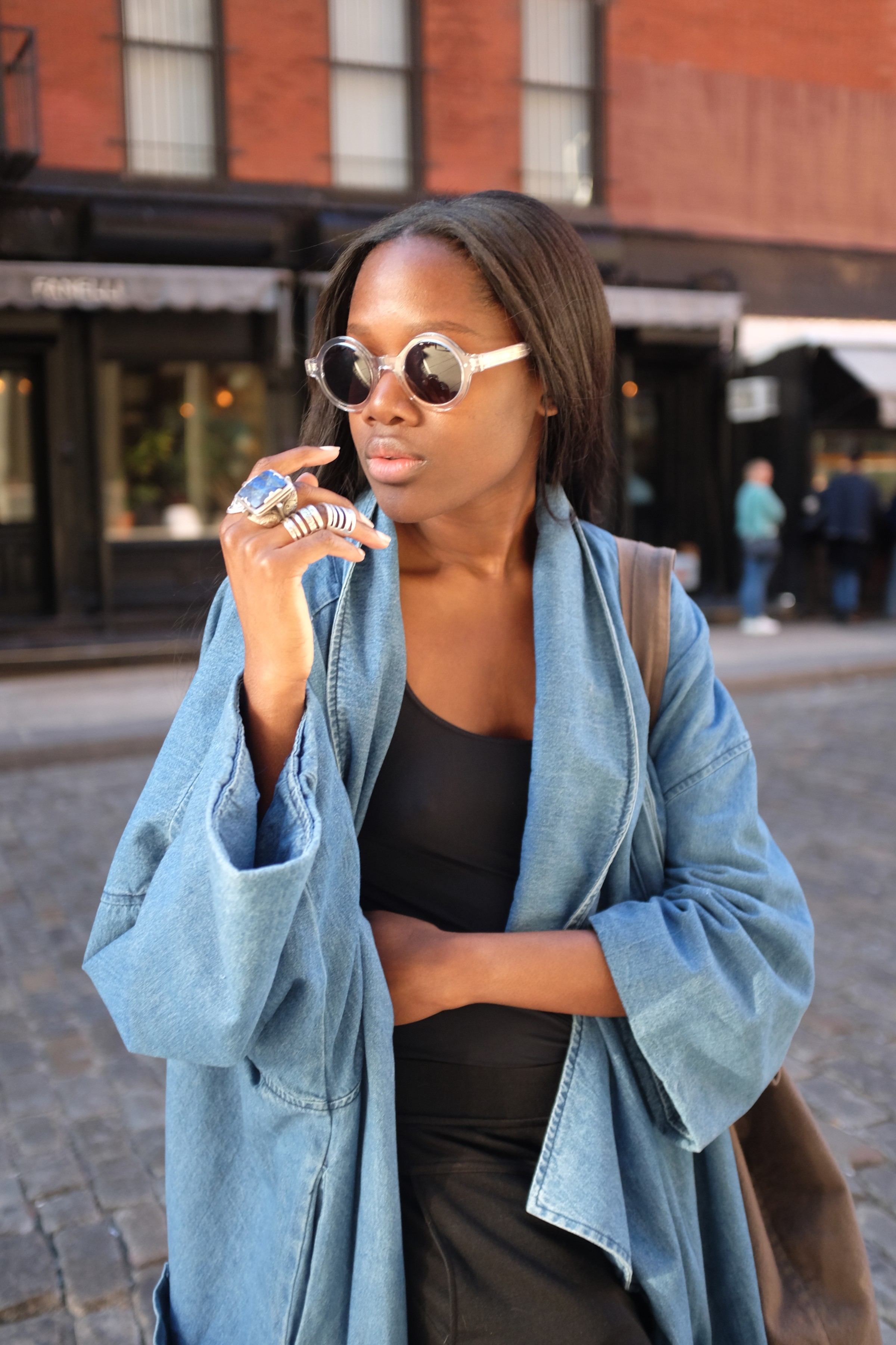 girl in sunnies and long denim jacket