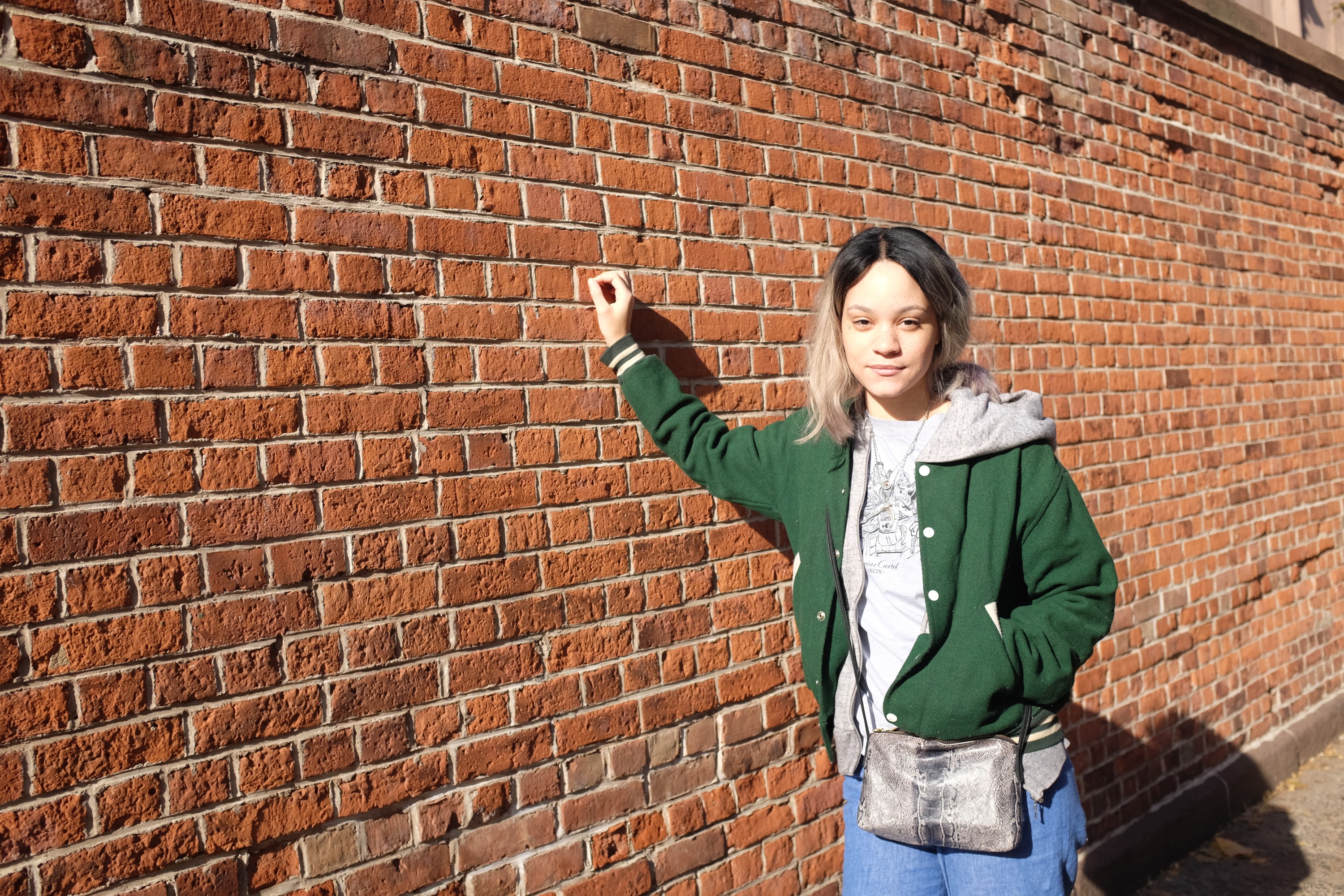 girl by brick wall
