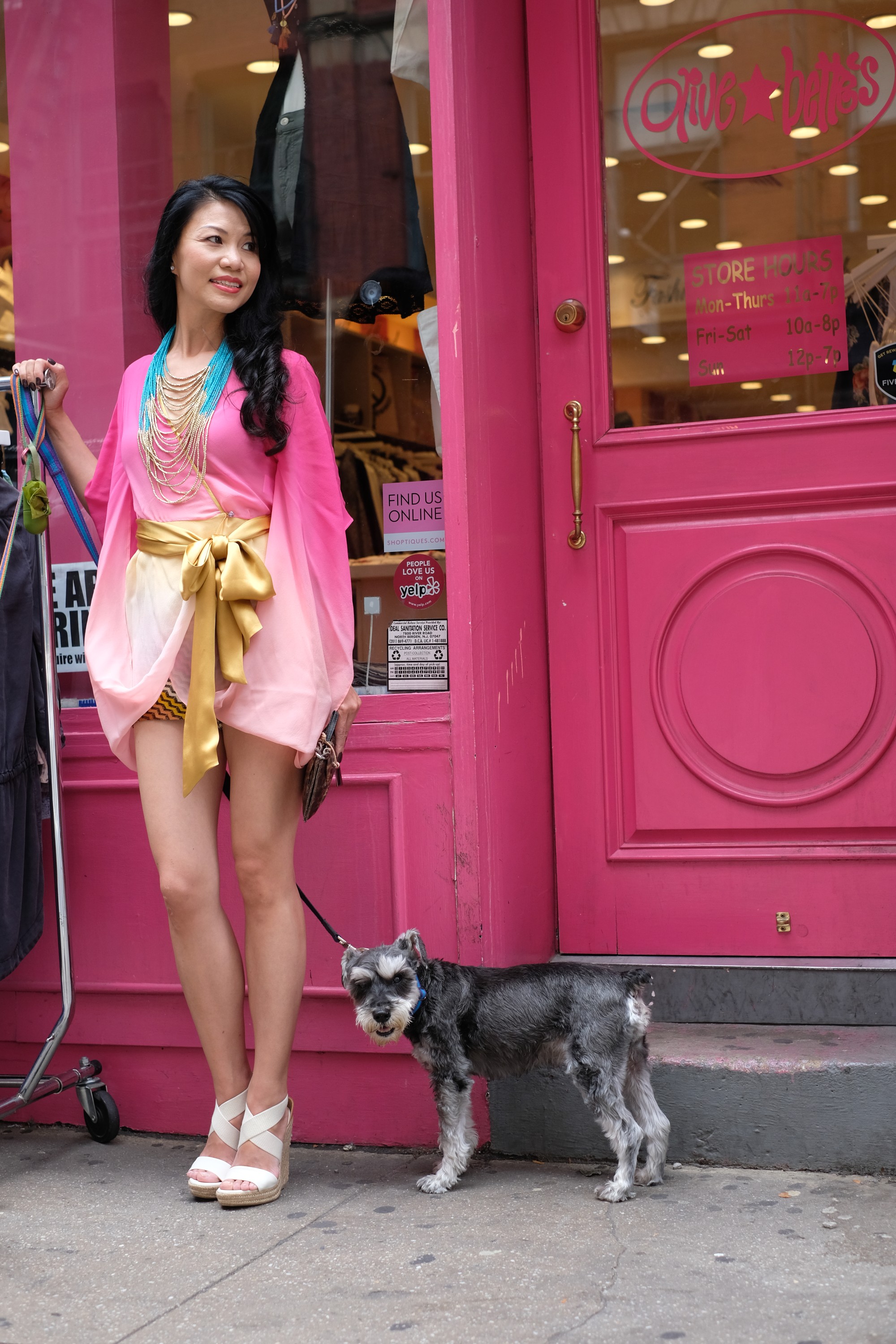 pretty girl in pink outfit with dog