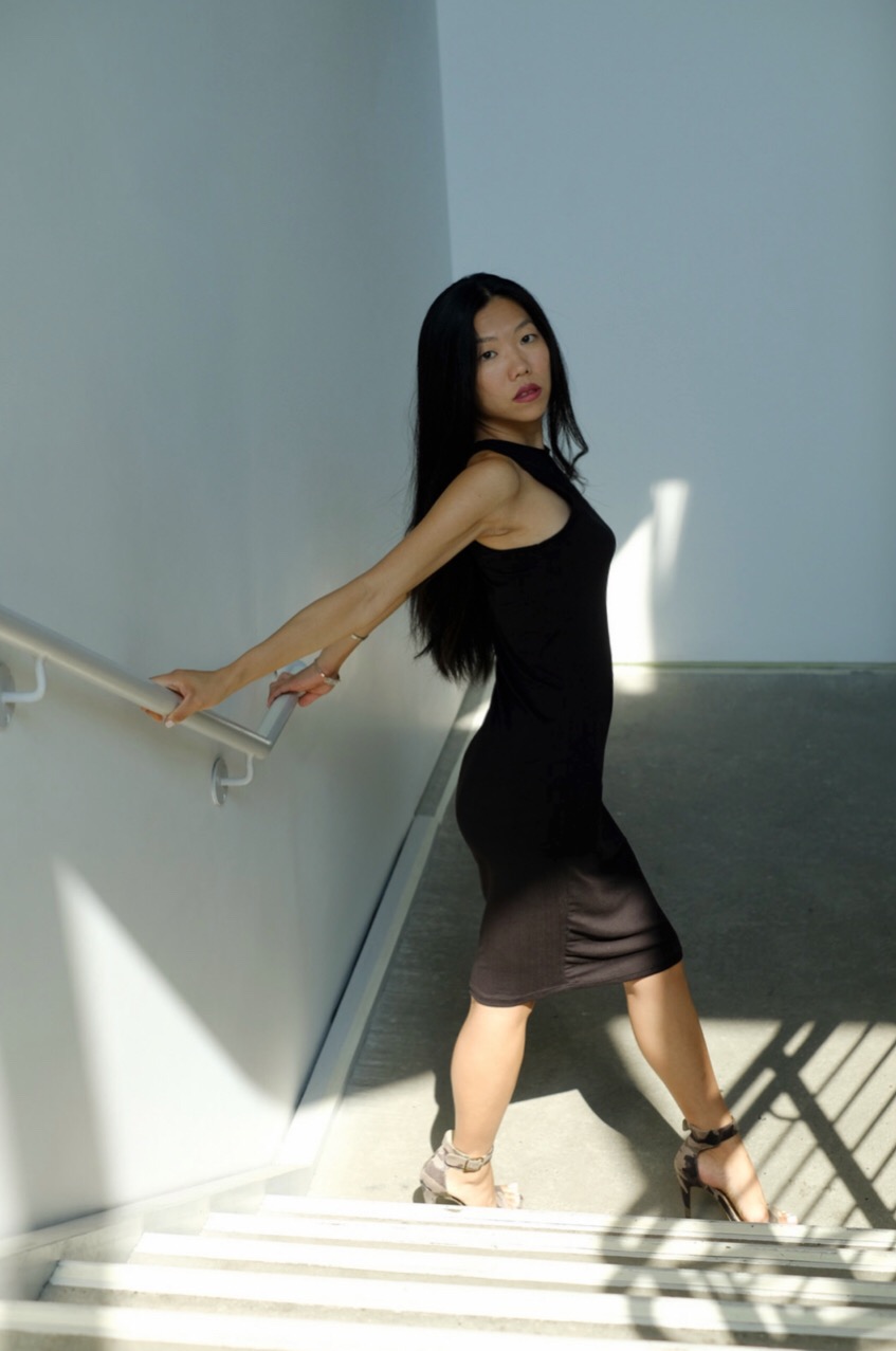 asian girl in black dress in stairwell