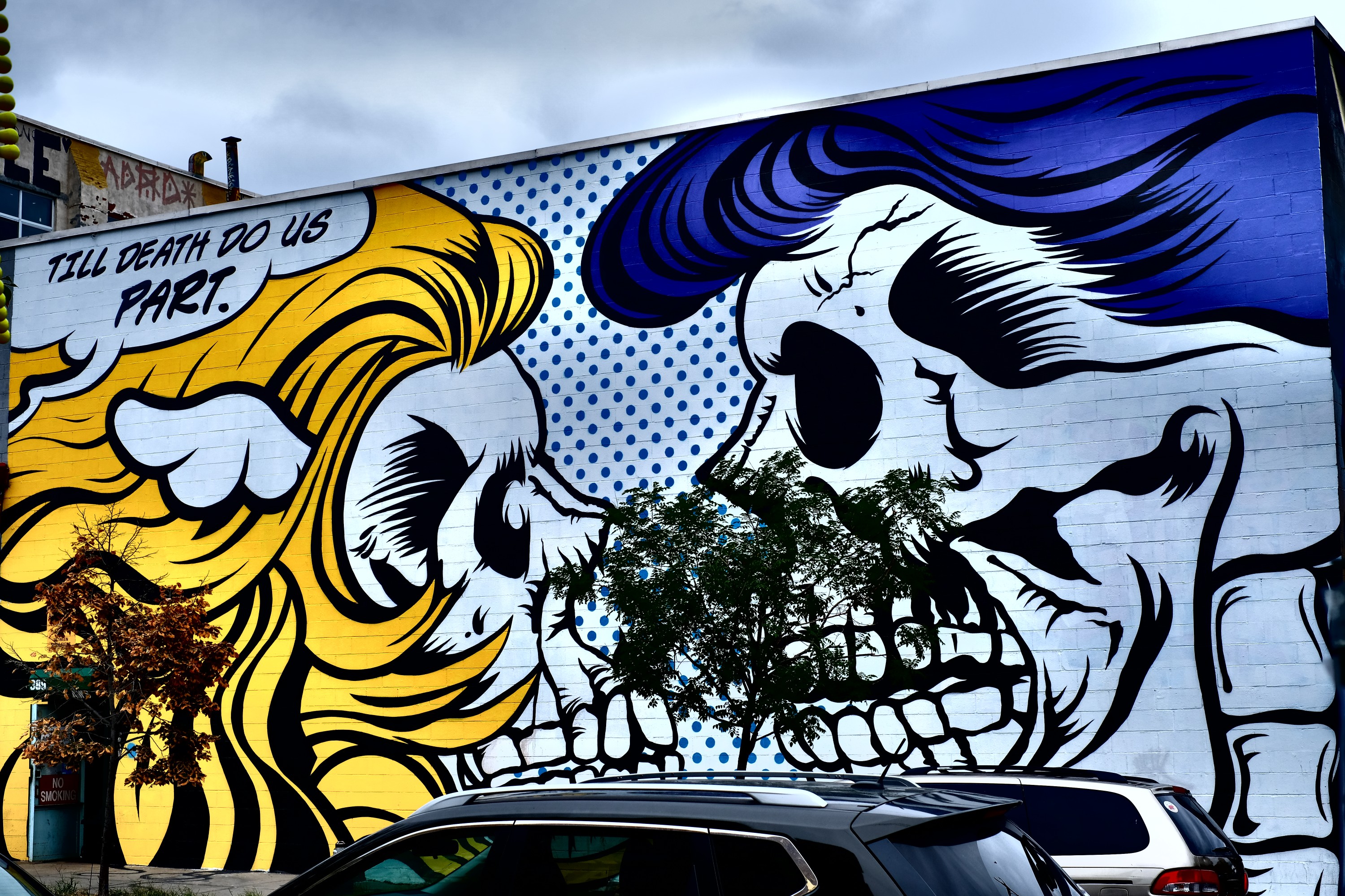 street art of two skulls facing each other