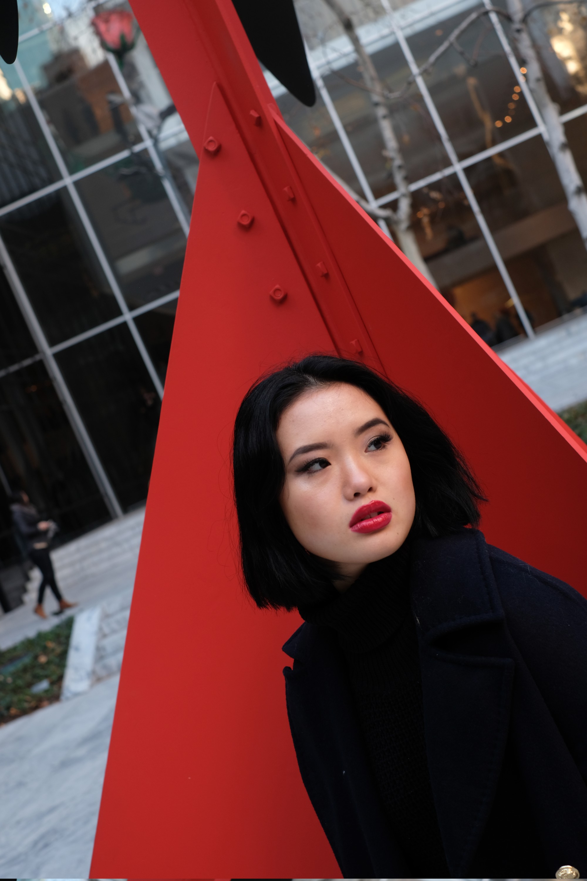 Chinese model by red Calder sculpture