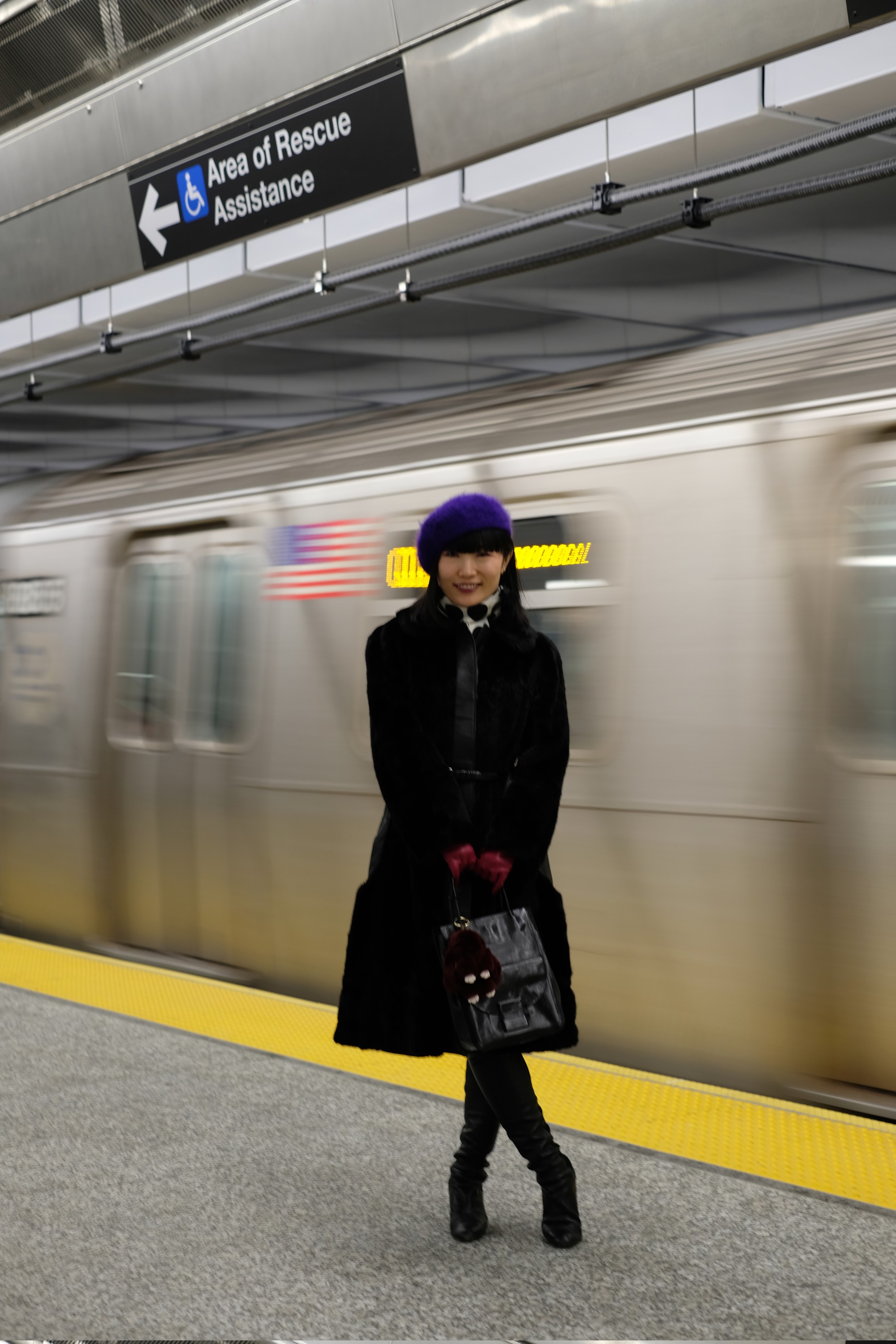Model standing by moving subway train