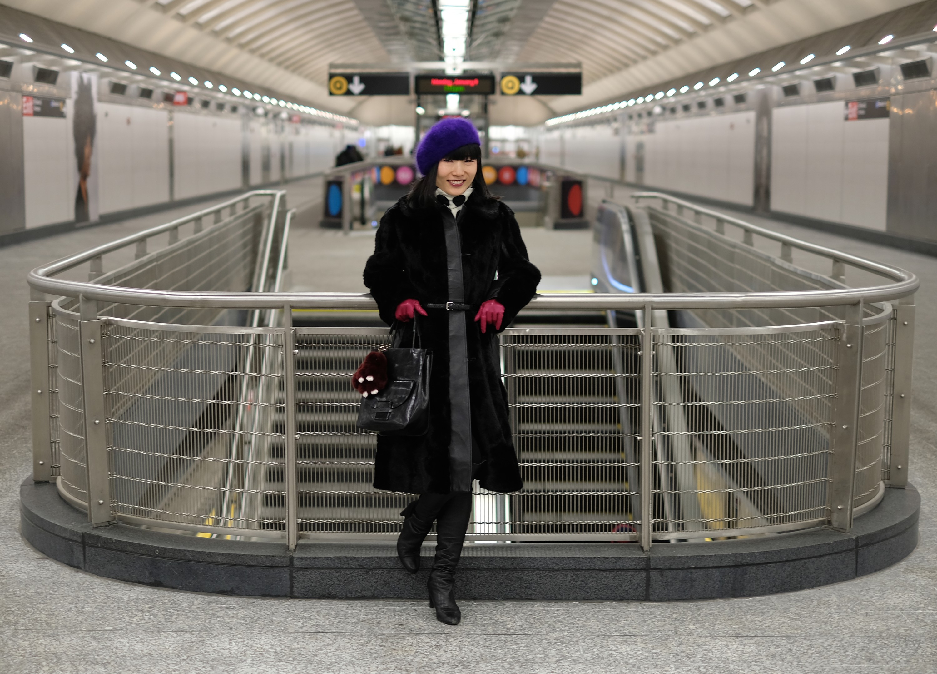 Japanese girl in black coat in new subway station