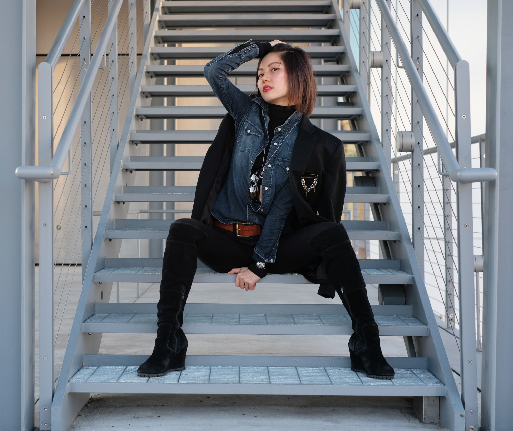 Asian girl sitting on metal stairs