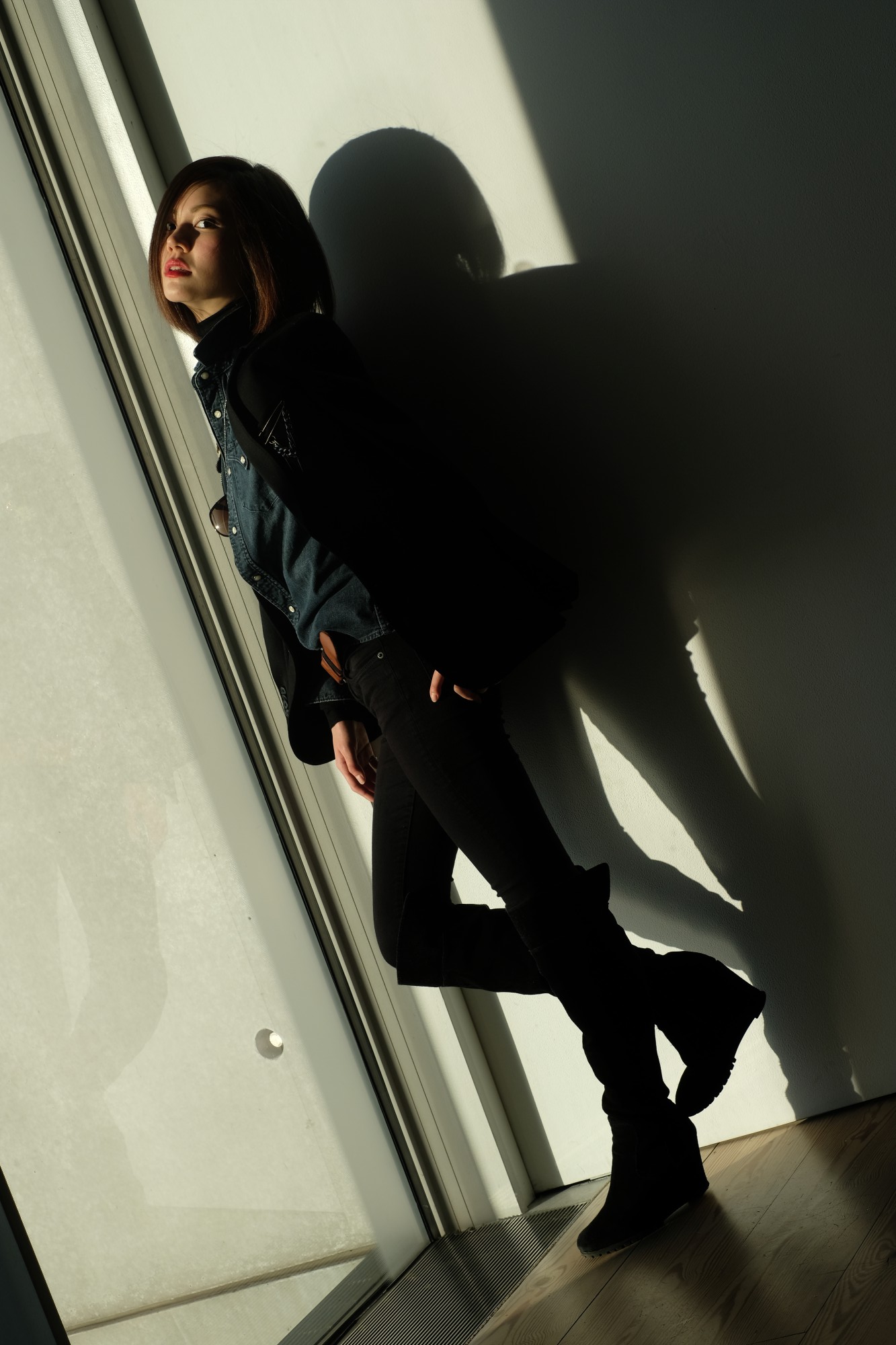 girl standing by window with shadows