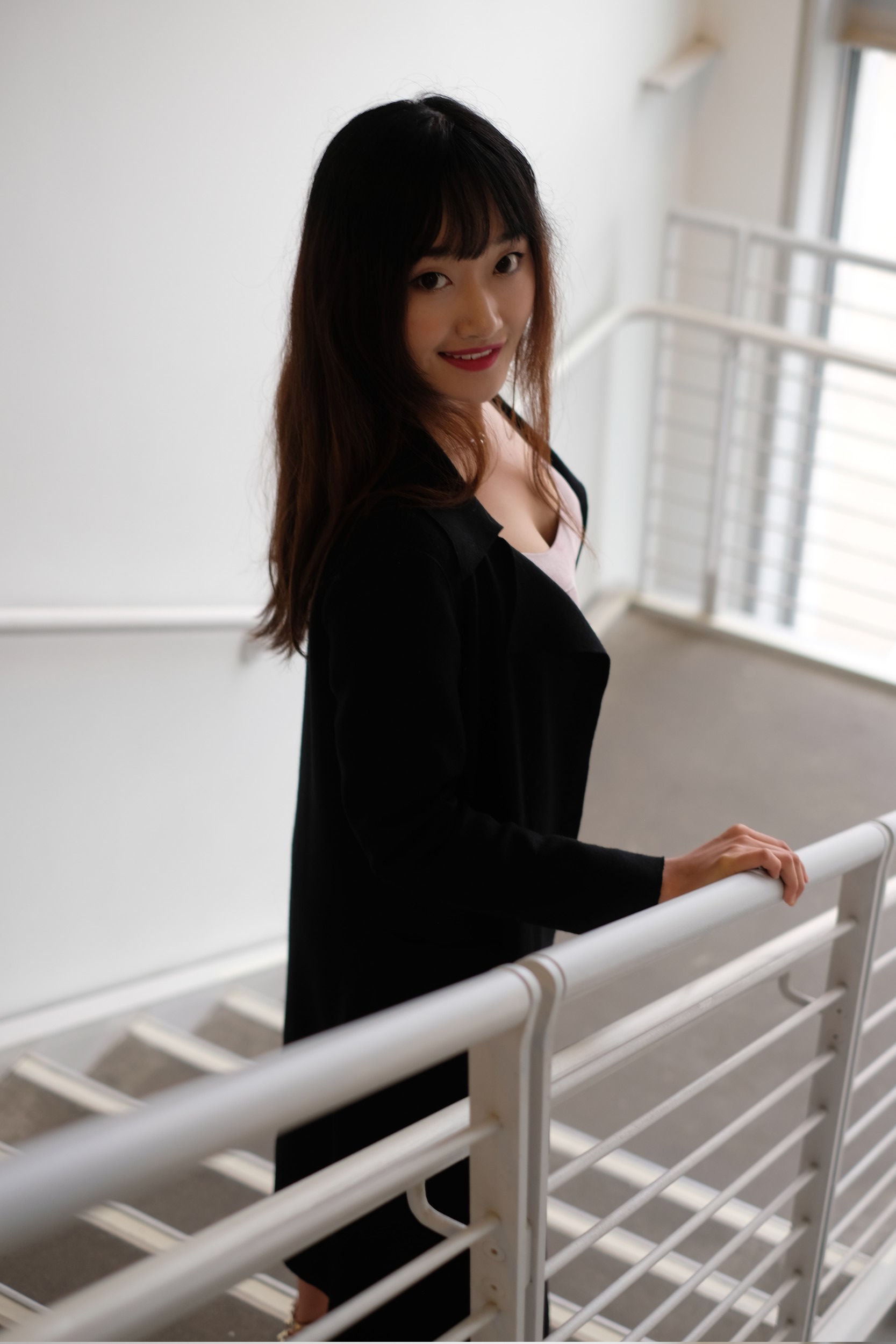 Chinese girl in black coat in stairwell